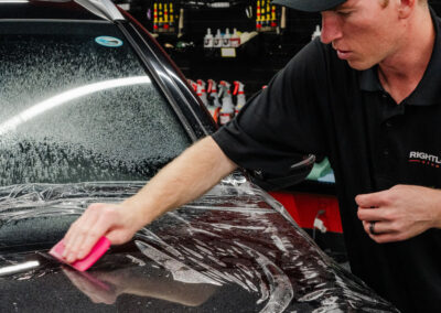 Rightlook Studio Applying Paint Protection Film to black Mercedes-Benz hood